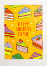 This is an image of a greeting card by Kiosk, that is illustrated by Georgia Perry. The card has a yellow background and illustrations of different types of cake slices scattered across the background. The cakes are in different colors and styles, including pink, green, and orange. The text on the card reads “Happy Birthday to You” in white letters. There are also small white stars scattered across the background.